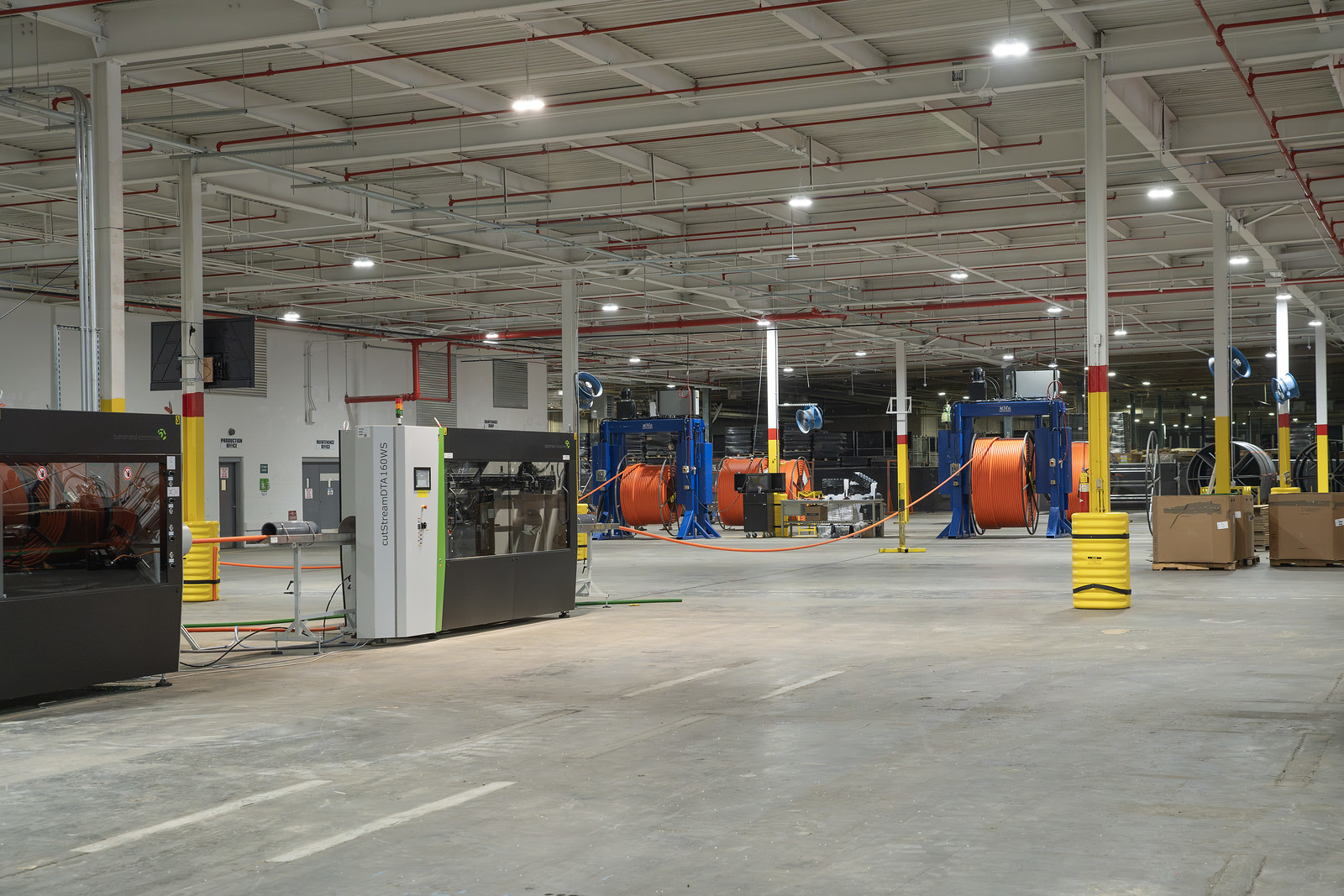 Reels of orange HDPE conduit staged on the production floor in Alto, Georgia