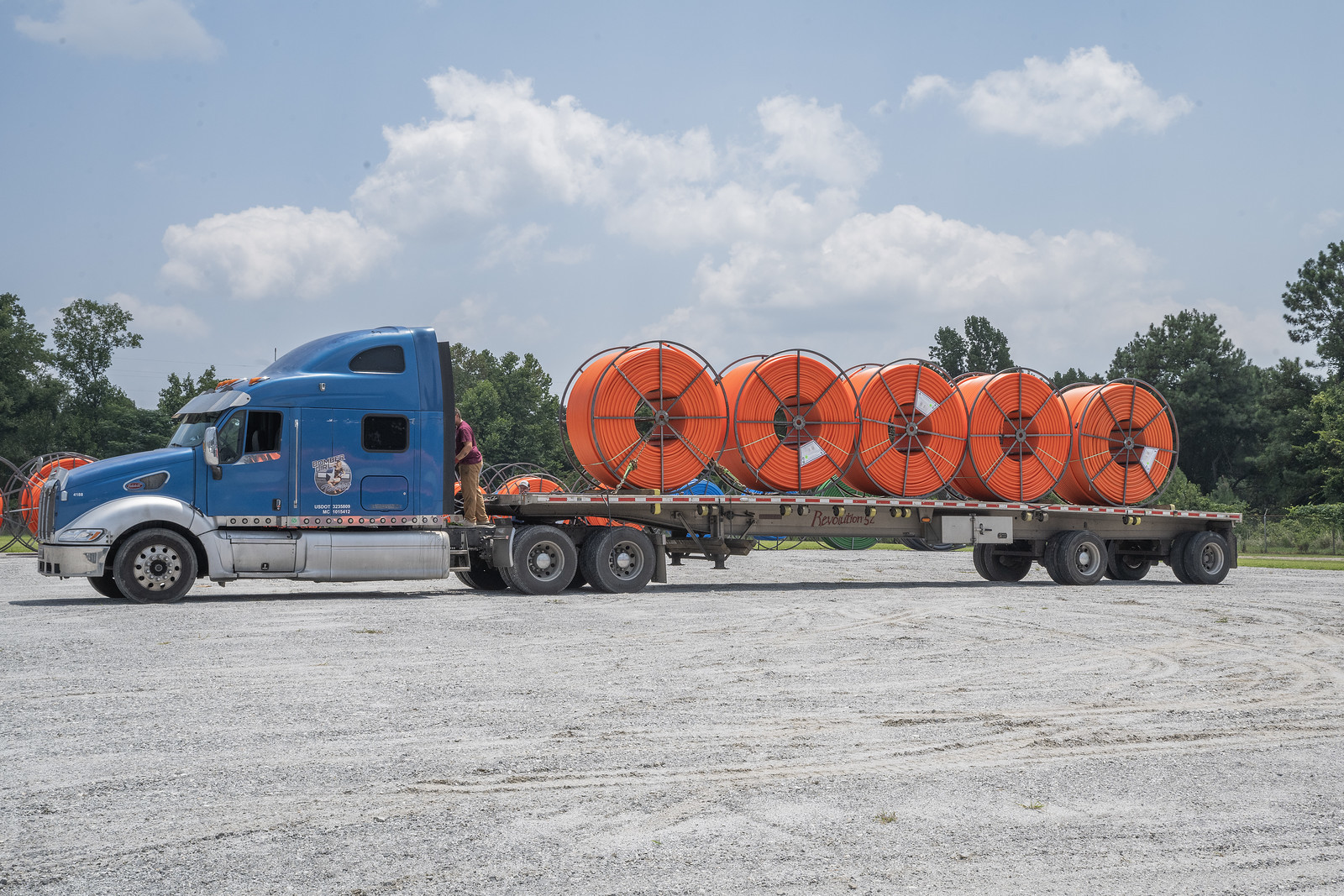A flatbed truck loaded with reels of orange HDPE conduit at the Alto, Georgia facility