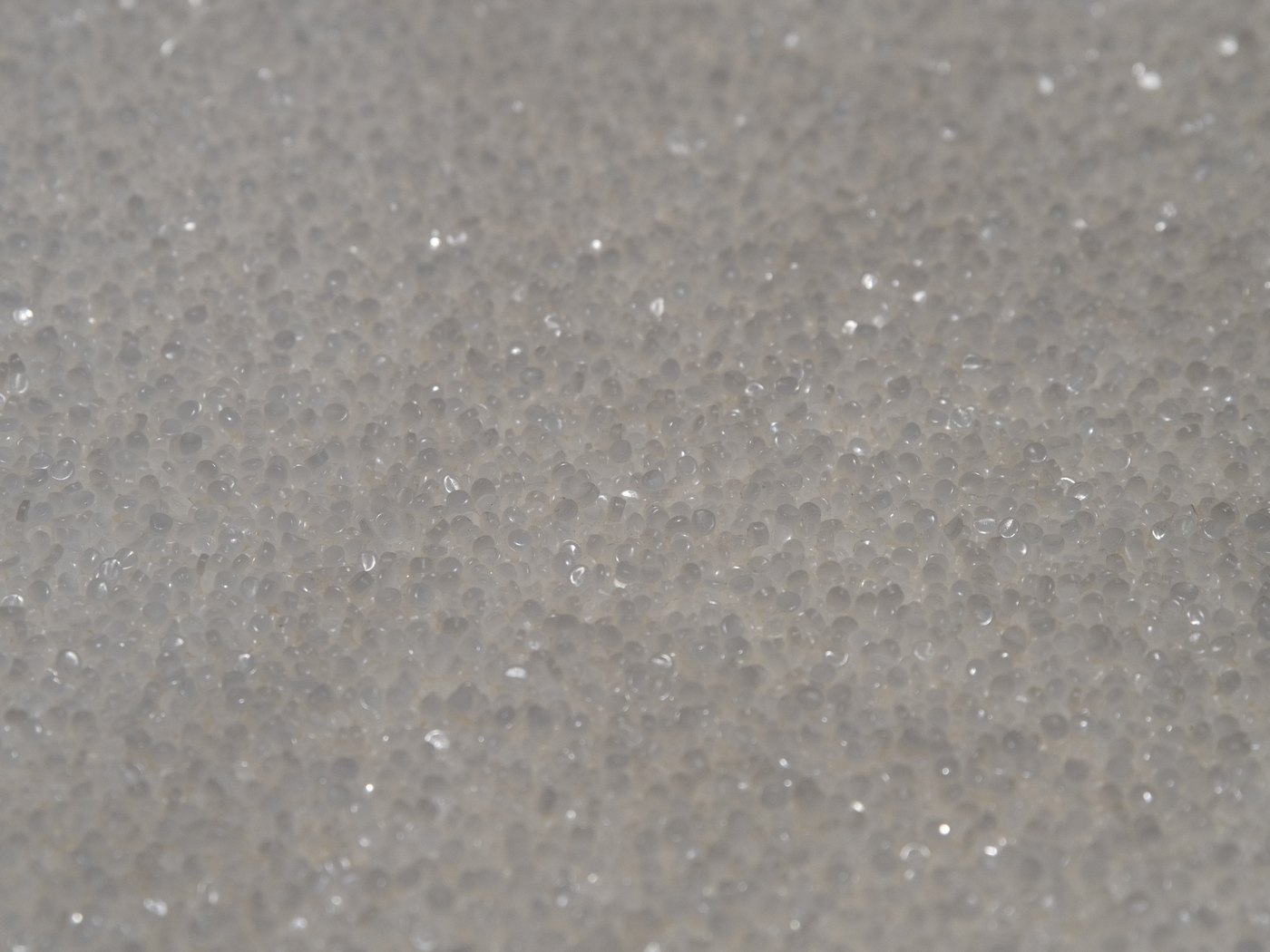 Close-up of virgin HDPE resin pellets, the raw material used to manufacture our conduit